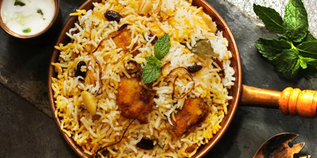 Flavourful biryani with Onion raitha and a bunch of mint from the beach restaurant of Bluebay beach restaurant